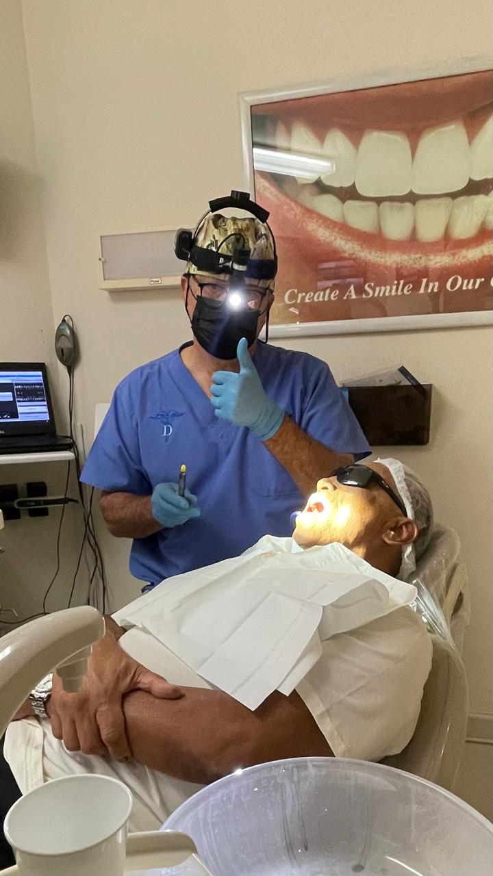 Happy patient giving thumbs up after dental treatment