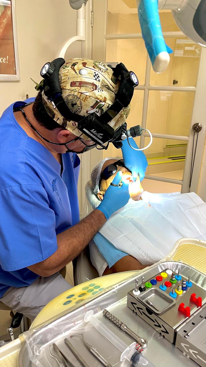 Dentist performing detailed dental work with magnification