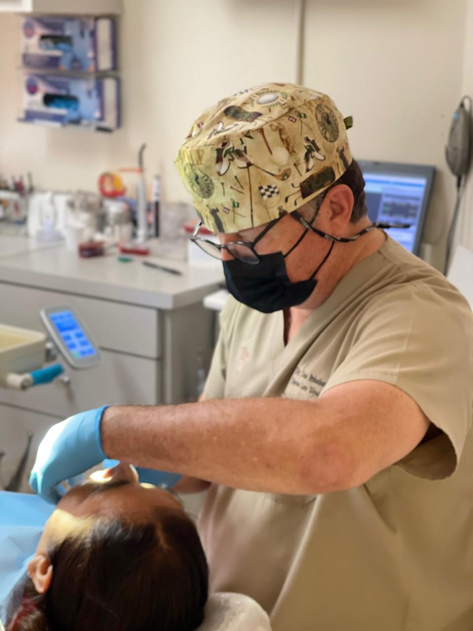 Dentist performing treatment in a modern exam room