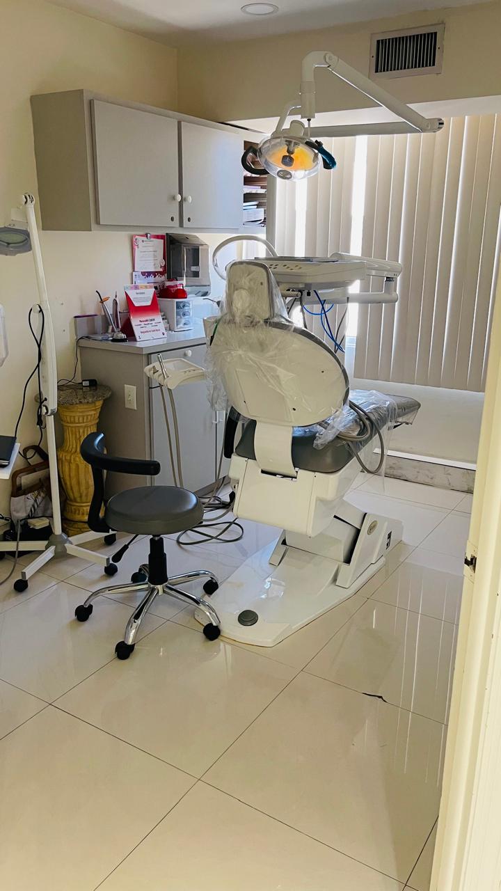 Bright, clean dental treatment room with patient chair